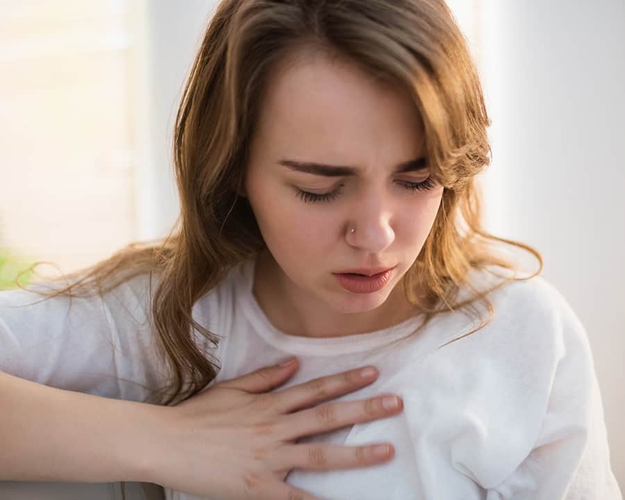 Pretty woman suffering from chest pain