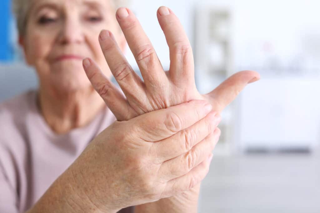 Elderly woman suffering from pain in hand, closeup arthritis