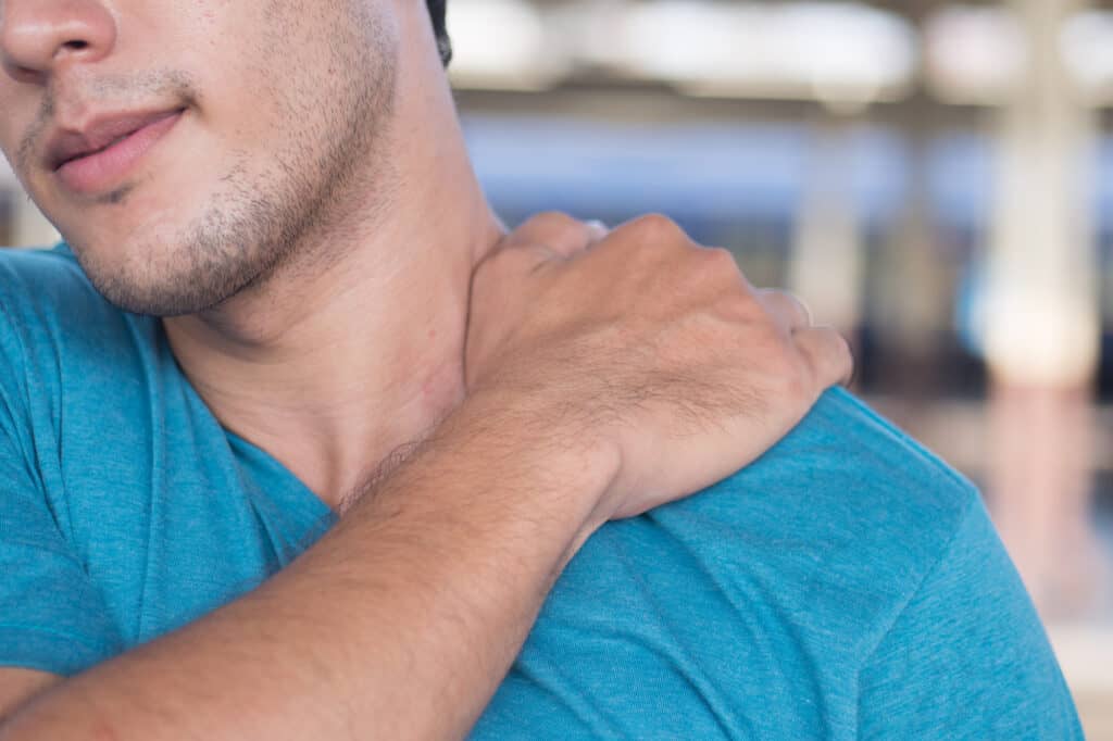 man suffer from stiff shoulder, muscle inflammation