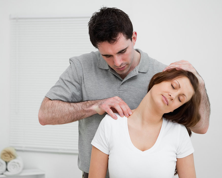 osteopath palpating the trapezius 