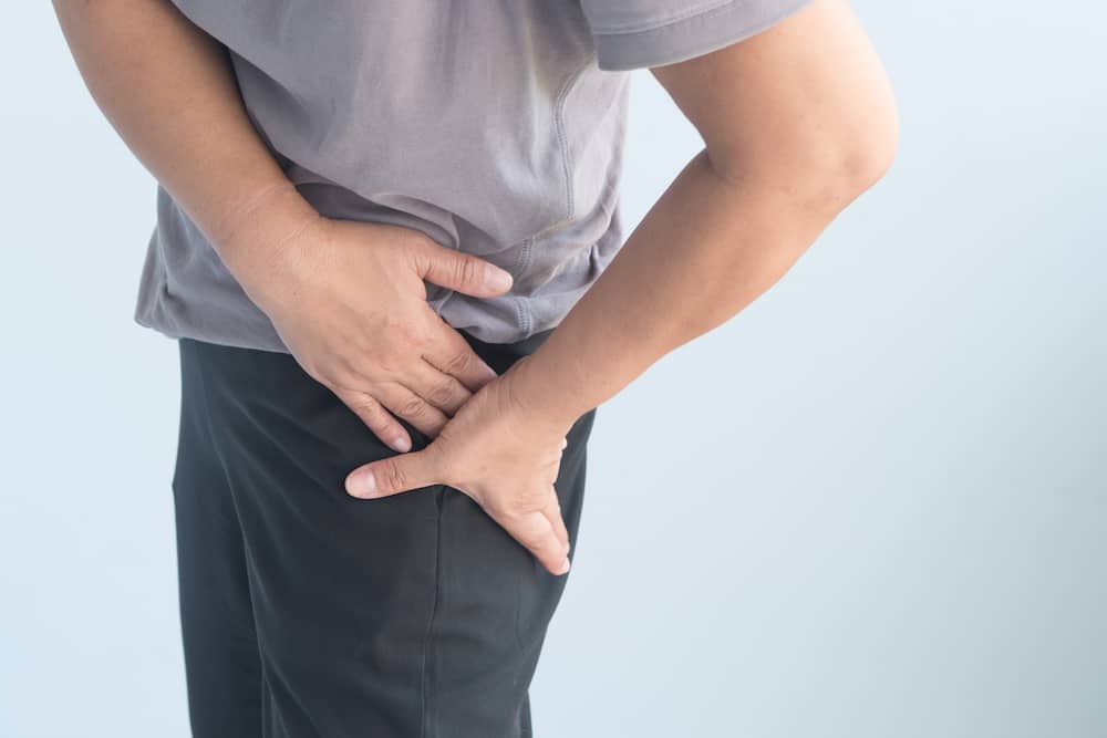 Man suffering from pelvic pain and hip stiffness